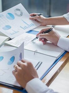 Close-up of a meeting of businesspeople to discuss the state of the financial markets.