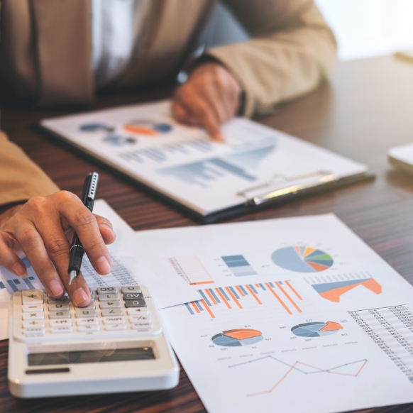 Professional working on financial data using calculator